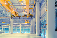 Concrete Floor Inside Factory Or Warehouse Building With Empty Space For Industry Background. Overhead Crane Or Bridge Crane Include Hoist Lifting For Transportation, Manufacturing, And Production.