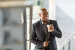 © digitalskillet1 - African American businessman drinking coffee on his way to work.