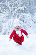 © Jekh - A beautiful little girl in a red coat and white hat with a scarf runs along a snowy path in a winter park. Smile and children's joy on the face. Enjoyment in the winter season. Great holidays. Snow