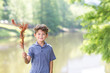 © digitalskillet1 - Handsome young boy with holding a feather.