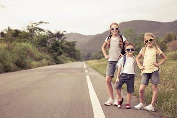 Wall Mural - Happy children  walking on the road at the day time.