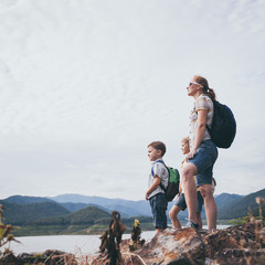 Canvas Print - Happy family standing near the lake at the day time.