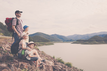 Wall Mural - Happy family standing near the lake at the day time.