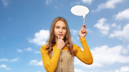 Sticker - communication and people concept - smiling teenage girl holding blank speech bubble over blue sky and clouds background