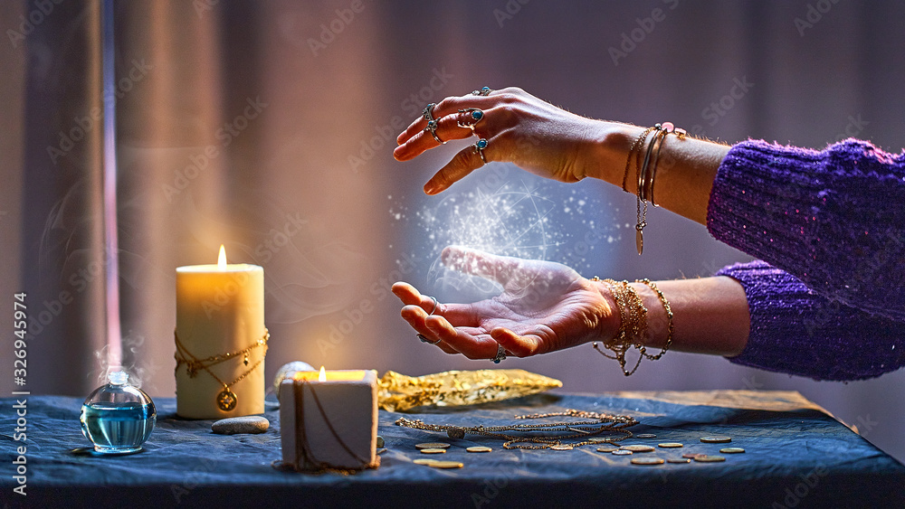 Magical luminous swirling glowing ball in the palm of a witch wizard woman during a witchcraft and occult esoteric spiritual ritual. Magic and sorcery - obrazy, fototapety, plakaty 