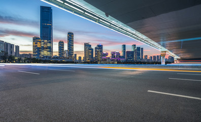 cityscape and skyline of shanghai from empty asphalt road.