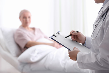 Poster - Doctor visiting his patient in hospital ward, closeup