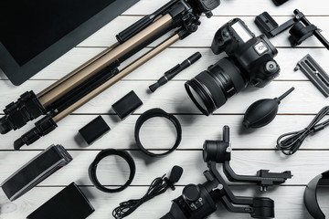 Wall Mural - flat lay composition with camera and video production equipment on white wooden table