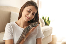 Woman Holding Bearded Lizard At Home. Exotic Pet