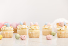 Selective Focus Of Easter Cupcakes With Painted Quail Eggs On Grey Background