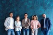 © opolja - Portrait of creative business team standing together and laughing. Multiracial business people together at startup
