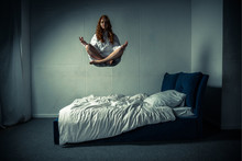 Obsessed Girl Levitating In Lotus Pose During Meditation Over Bed