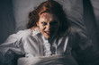 top view of paranormal girl in nightgown lying in bed