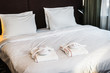 © OlegDoroshin - large bed with pillows in the hotel and bathrobes with Slippers for guests