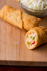 Egg rolls or spring rolls fried.Traditional Chinese Thai restaurant appetizer, spring rolls or egg rolls. Made from wonton wrappers and filled with Chinese veggies and served w/ chili dipping sauce.