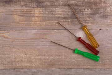 Wall Mural - small screwdriver tools on gray wooden background