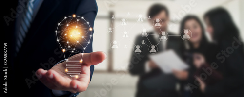 Cuadros en Lienzo Innovation and idea of professional leader holding lighting bulb, business peopl