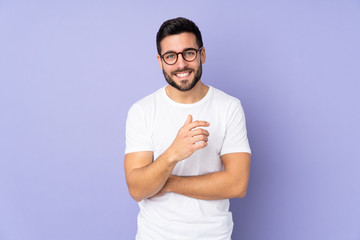 Canvas Print - Caucasian handsome man over isolated background laughing