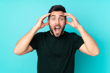 Fototapeta  - Caucasian handsome man isolated on blue background with surprise expression