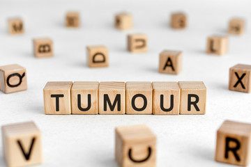 Wall Mural - Tumour - words from wooden blocks with letters, a mass of diseased cells tumour concept, white background