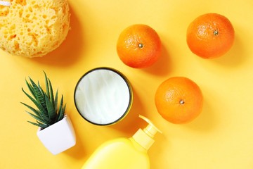 Flat lay beauty photography. Wrapped gift box, moisturizing cream, face wash cleansing gel, aloe vera and mandarins