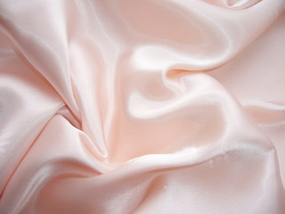 Pink silk fabric with drapery. The texture of the fabric. Natural silk. Silk scarf, silk scarf.