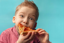 Little Boy Eats A Slice Of Pepperoni Pizza. Kids Love Pizza