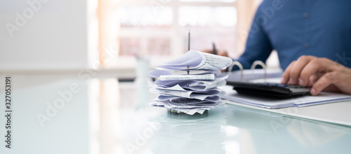 Cuadros en Lienzo Businessman Calculating Invoice