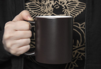 Mock-up of black coffee mug girl woman holds in her hands