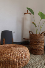 Aesthetic Interior. Sitting Corner Has Floor Lamp, Floor Mat, Plants And Chair. Plants Basket And Chair Made From Water Hyacinth
