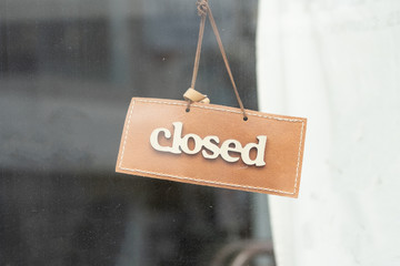 Wall Mural - sorry we are closed sign hanging outside a restaurant, store, office or other