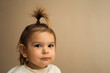 © troyanphoto - Toddler baby girl with fountain hairstyle and smiling with her teeth