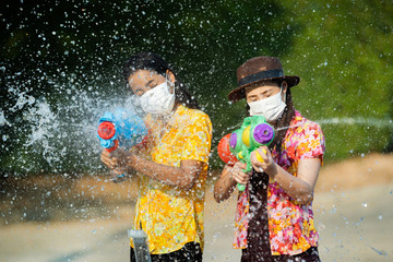 Wall Mural - Asian people wear masks to protect against viruses. In the Songkran festival in Thailand in April