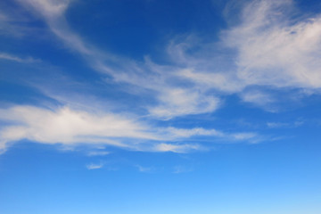 the bright blue sky background with some white cloud