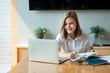 © amnaj - Young asian businesswoman sitting on her workplace in the office. Young woman working at laptop in the office.