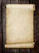 Leinwandbild Motiv Old scroll paper on wood plank