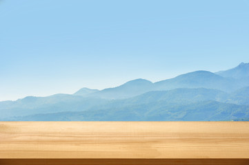 Wall Mural - Wooden table top advertise stand product display with blue mountains background