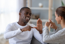 Smiling African American Man And Woman Speaking Sign Language