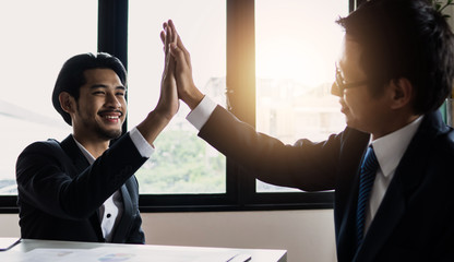 Wall Mural - ิีbusinessman punch with partner in office, friendship and teamwork of success and cooperation