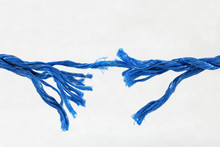 Fraying Blue Rope On White Background Showing Concept Of Breaking Strain, Stress, Tension, Under Pressure. With Space For Text