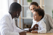 © fizkes - African American pediatrician listening to child lung and heart sound