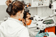 © Natalya Lys - Two dentists treat a patient. Professional uniform and equipment of a dentist. Healthcare Equipping a doctor’s workplace. Dentistry