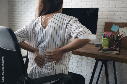 Fotografía Business woman suffering from back pain in office