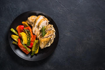 Baked chicken with vegetables top view.