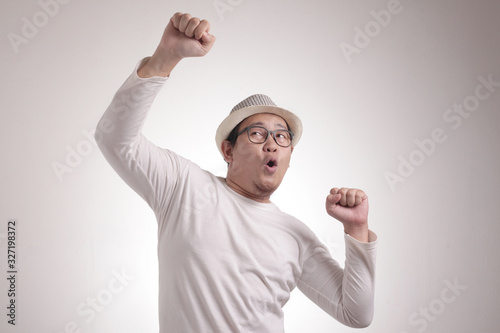 Cuadros en Lienzo Happy Funny Asian Man Dancing Full of Joy, Winning
