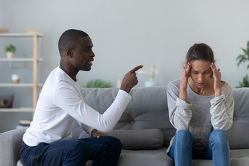 Wall Mural - Angry African American man blaming woman, family conflict