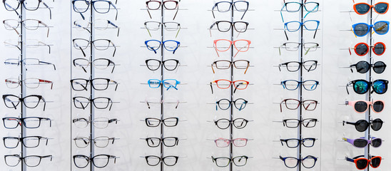 Showcase with spectacles in modern ophthalmic store. Eyeglasses shop. Eyesight correction.