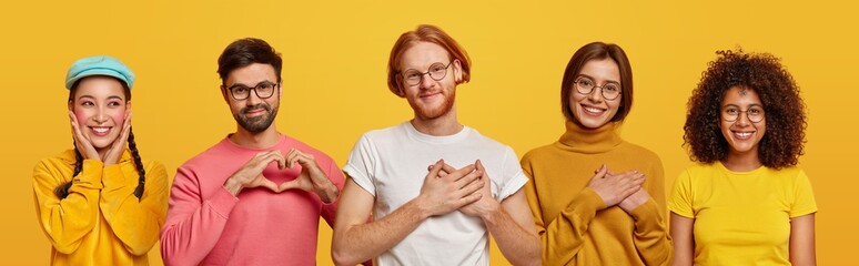 Group of people show love and sympathy, make heart gesture, express gratitude, being thankful for something, isolated over yellow studio background. Collage composition. Body language concept