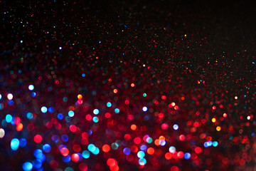 Multicolored shining glitter in focus and out of focus, abstract shiny background