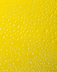  drops of water on a yellow glass
